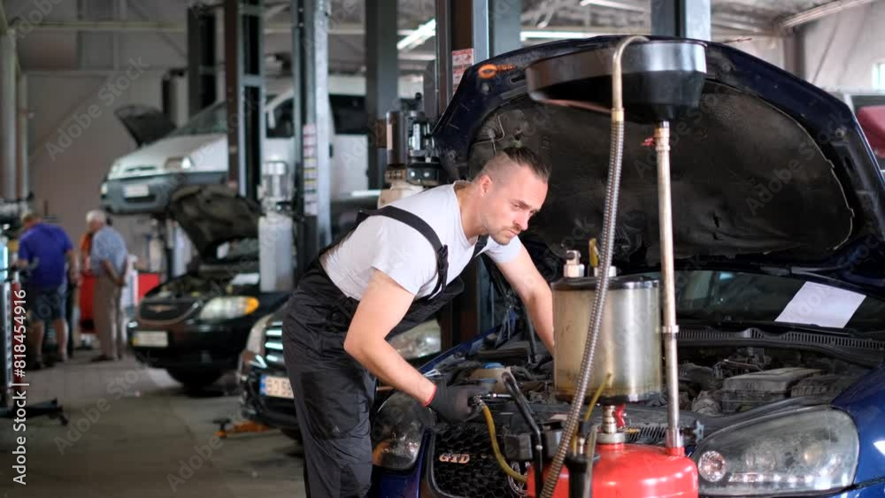 Mechanic working on motor vehicle engine in garage Mechanic working on motor vehicle engine in garage