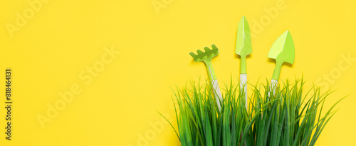 Foto Yellow banner with green grass and gardening tools