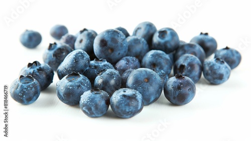 A close-up of fresh, plump blueberries scattered on a white surface, showcasing their vibrant blue color and natural texture.