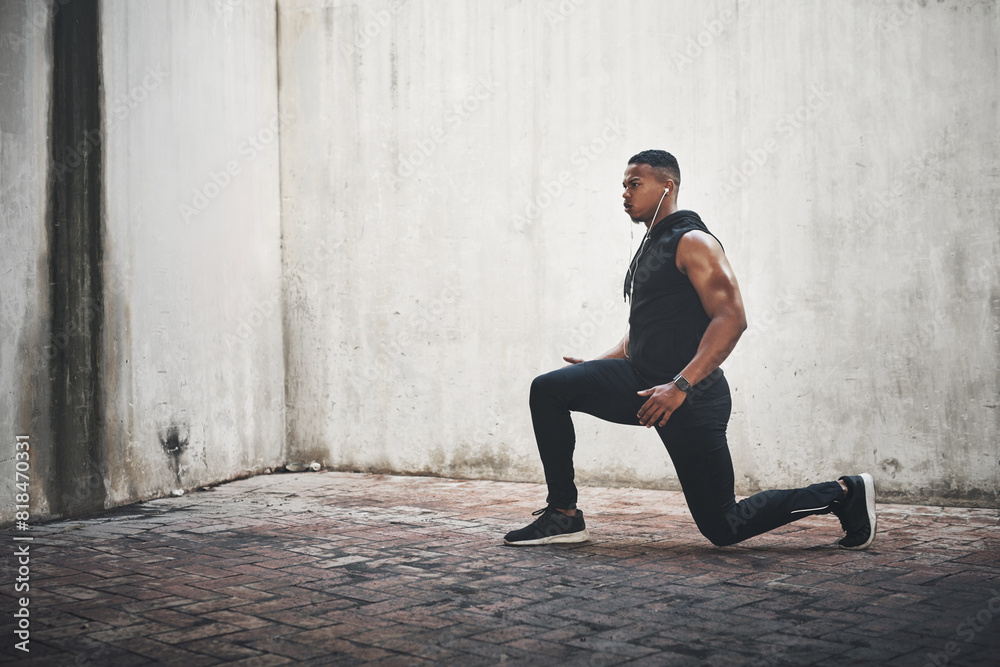 Man, fitness and lunge with earphones in city for strong muscle, balance and exercise for wellness. African person, music and workout for legs with listening, health or audio streaming in New York Man, fitness and lunge with earphones in city for strong muscle, balance and exercise for wellness. African person, music and workout for legs with listening, health or audio streaming in New York