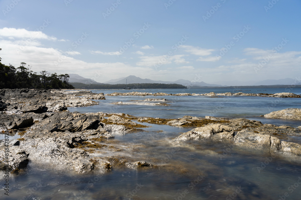 sailing on a yacht in the australian in the remote forest wilderness in spring, with waves breaking on a beach on the australian coastline sailing on a yacht in the australian in the remote forest wilderness in spring, with waves breaking on a beach on the australian coastline