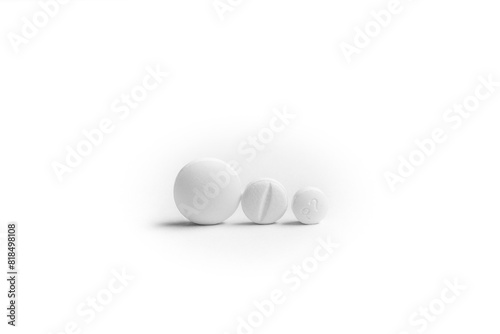 Three white generic pills next to each other on white background.