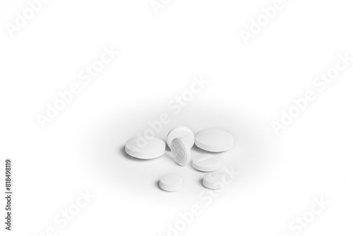 Seven white generic pills next to each other on white background.