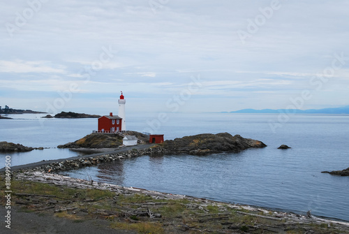 A Canadian lighthouse against the pacific ocean at Fort Rodd Hill in Victoria BC photo