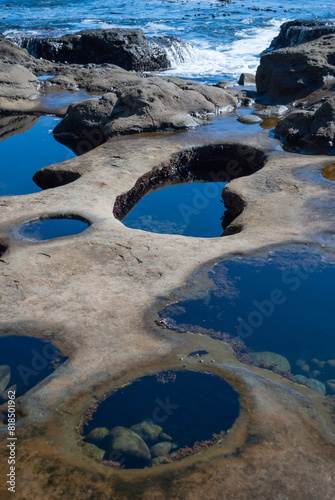 Rugged tide pools and driftwood on the stormy pacific coast of Vancouver Island near Tofino BC