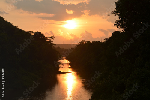 sunset over the river with a reflection. Seethawaka river ,  Sri Lanka. photo