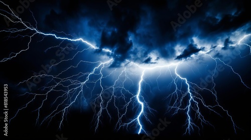 Intense lightning strike, illuminating the dark sky with sharp, bright electric arcs, set against a pitchblack background for dramatic effect photo