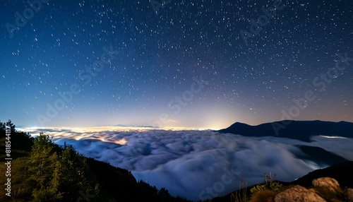 Majestic Night Sky Above Clouds Illuminated by Starlight