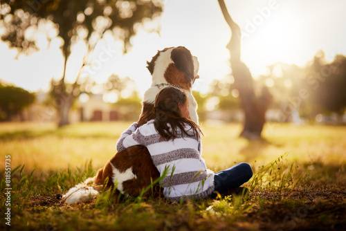 Hug, dog and girl child in park for affection, friendship or cuddle pet in nature. Back, animal and young kid with embrace for companion, Saint Bernard or bonding together with love in Washington