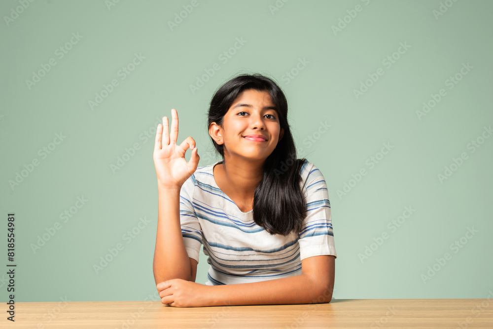 Indian asian small girl showing ok, perfect sign or thumbs up Indian asian small girl showing ok, perfect sign or thumbs up