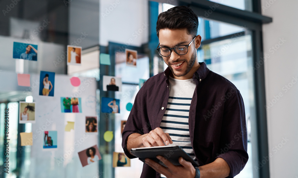 © peopleimages.com - Businessman, browsing internet or tablet in office with sticky notes for online research and brainstorming. Male person, technology and headshot on transparent wall for model agency or social media
