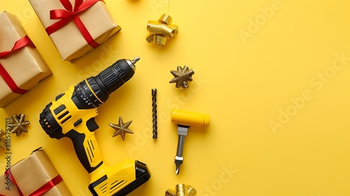 Handheld cordless power drill hand battery screwdriver and gift boxes on yellow background photo