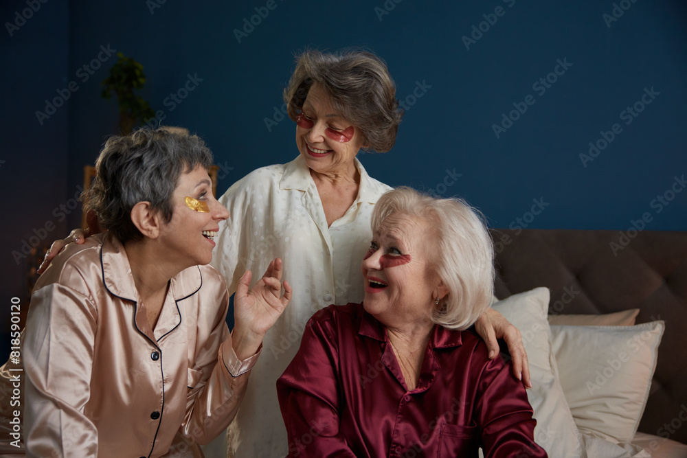 Laughing senior female friends speaking doing skincare rejuvenation procedure Laughing senior female friends speaking doing skincare rejuvenation procedure