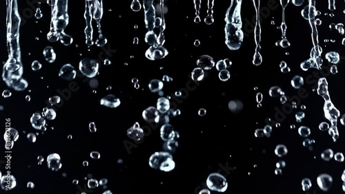 Super Slow Motion Shot of Falling Water Droplets Isolated on Black Background at 1000 fps.