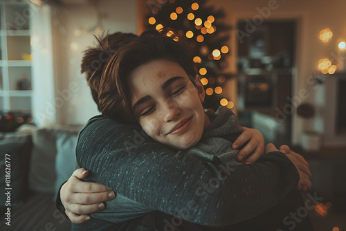 Happy mother hug her teenage son and rejoices because she is reconciled with her son with whom she had a complicated relationship photo