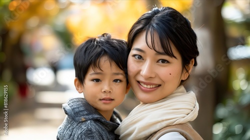 A woman and her son are smiling for the camera.