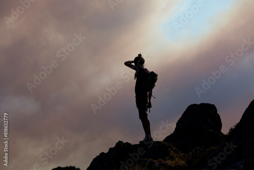 Hiker observing atop of Roc'h Bichourel the fire in the Monts d'Arrée