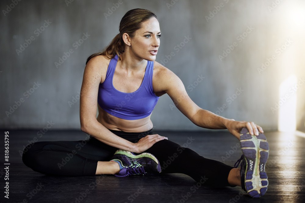 Fototapeta premium Woman, stretching legs and athlete for workout exercise gym and studio floor. Personal trainer, fitness and wellness flexibility or healthy body, release tension or muscle cardio sports warm up