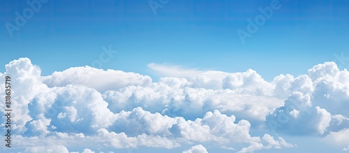 A background image with a clear blue sky and fluffy clouds has a copious amount of copy space for you to utilize photo