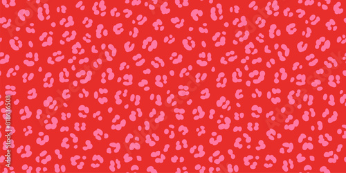 Hot pink on red leopard skin print seamless pattern. Pink cheetah spots on vivid red background trendy fun safari print.