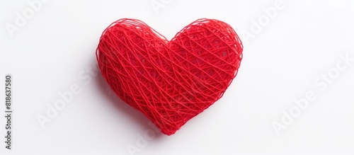 Valentine s Day themed image of a heart crafted from red yarn against a white backdrop A copy space image