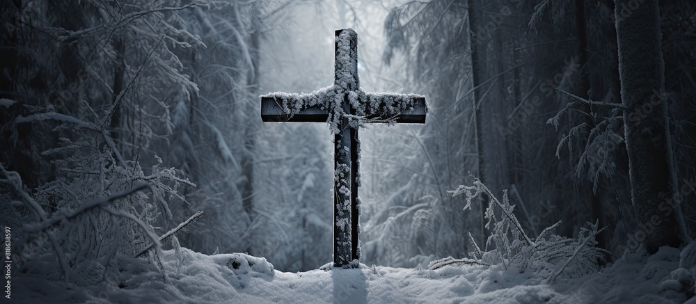 In a snowy forest a copy space image reveals a wooden cross symbolizing faith