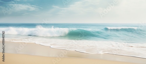 A tropical beach with blurred waves and sand in the foreground Offers plenty of copy space for your image photo