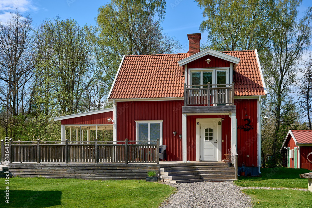 Beautiful red wooden house with big terrace and balcony.   