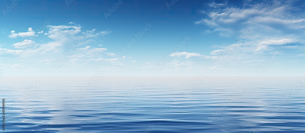 A serene scene with a clear blue sky mirrored in a calm blue ocean creating a captivating copy space image A serene scene with a clear blue sky mirrored in a calm blue ocean creating a captivating copy space image