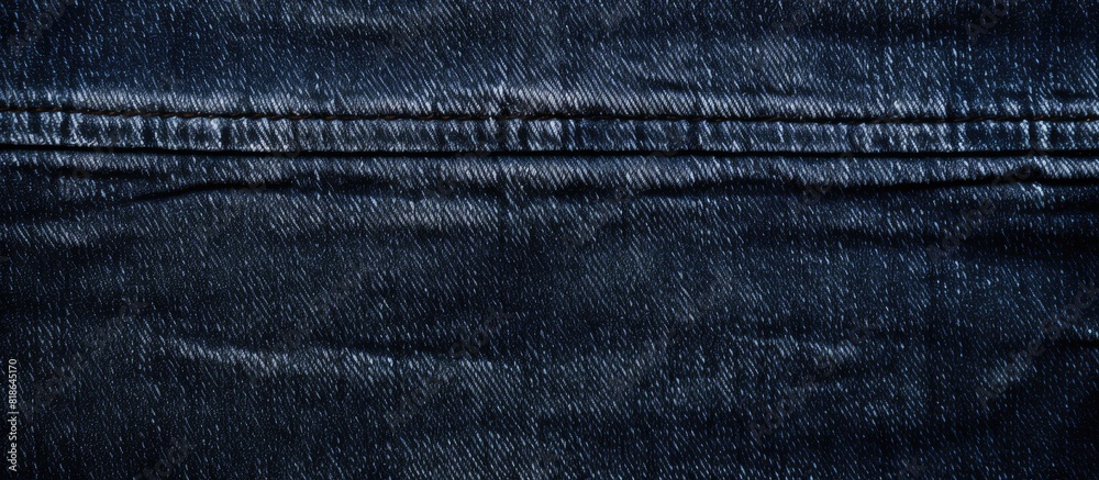 A close up image of the textured background of a pair of dark wash indigo blue jeans providing ample copy space A close up image of the textured background of a pair of dark wash indigo blue jeans providing ample copy space