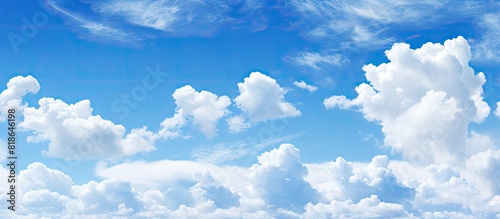 Blue sky with white clouds as a copy space image for a background