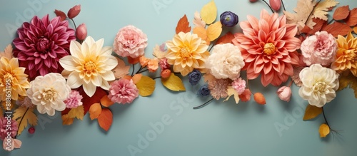 Copy space image featuring a top view of delicate autumn flowers arranged in a composition with a festive background The flowers can be used to create a floral card or a floral frame