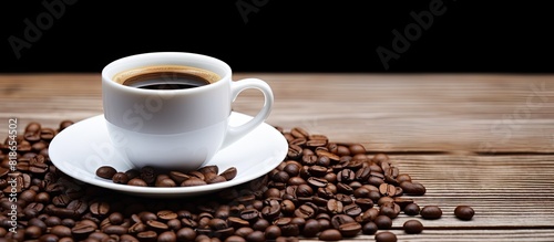 White mug with a cup of black coffee and coffee beans providing copy space image