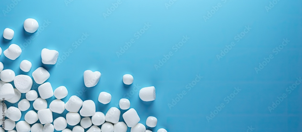 Blue background with copy space image of a birthday greeting card adorned with marshmallows and beads Blue background with copy space image of a birthday greeting card adorned with marshmallows and beads