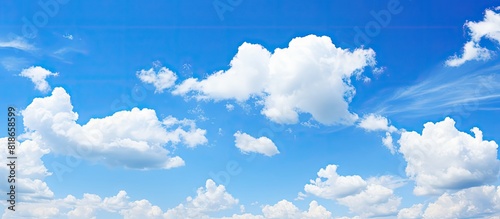 Fototapeta Naklejka Na Ścianę i Meble -  A bright and sunny day with clear blue skies scattered clouds and ample copy space image