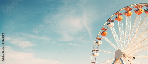 Picture of a vintage ferris wheel against a beautiful blue sky with ample copy space