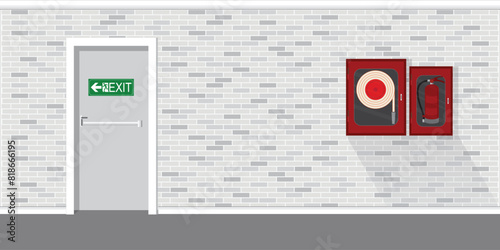 Fire extinguisher with green emergency fire exit sign door.