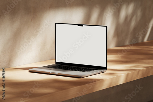 Apple MacBook Pro on the wooden desk on a plaster background