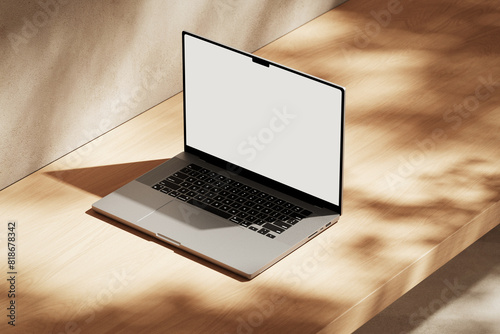 Apple MacBook Pro on the wooden desk on a plaster background