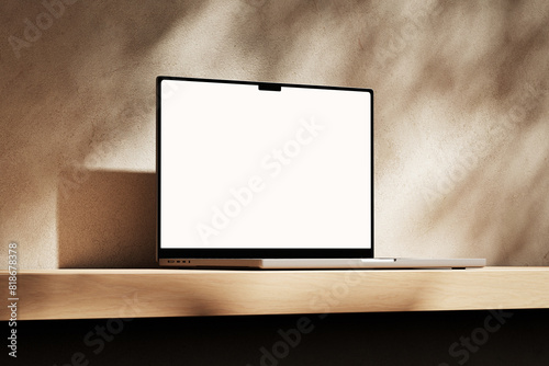 Apple MacBook Pro on the wooden desk on a plaster background