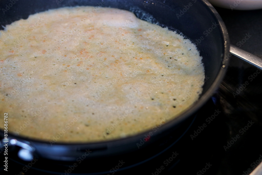 Close up of a lentils pancake in a pan Close up of a lentils pancake in a pan