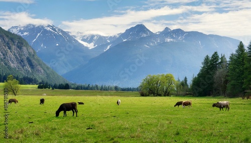 A serene alpine meadow with grazing wild animals and distant mountains. 