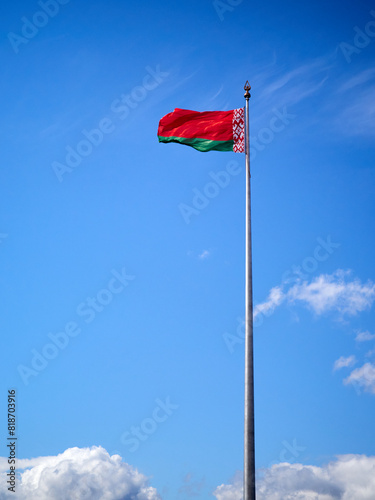 National flag of the Republic of Belarus against the blue sky