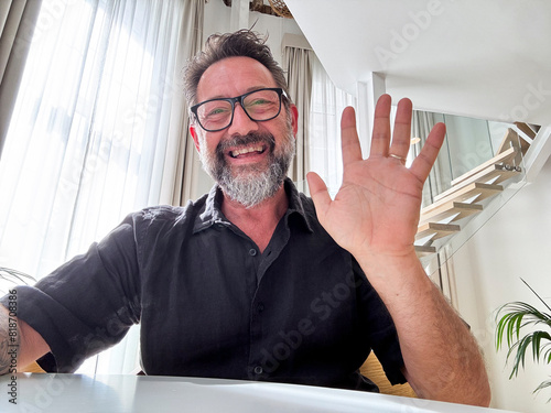 Cheerful adult man enjoy videocall using laptop. Web camera view. Gesturing and smiling with friends online. Happy business solution. Modern worker video call team. Smart working happiness freedom