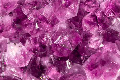 Amethyst purple crystals. Gems. Mineral crystals in the natural environment. Texture of precious and semiprecious stones. Seamless background with copy space colored shiny surface of precious stones.
