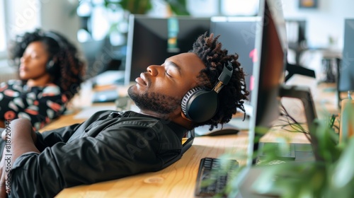 Yawning, exhausted call center workers sleeping on computer desks in contact us, consultancy, and customer service offices. A tired black woman, guy, or bored team member from overdone crm assignment