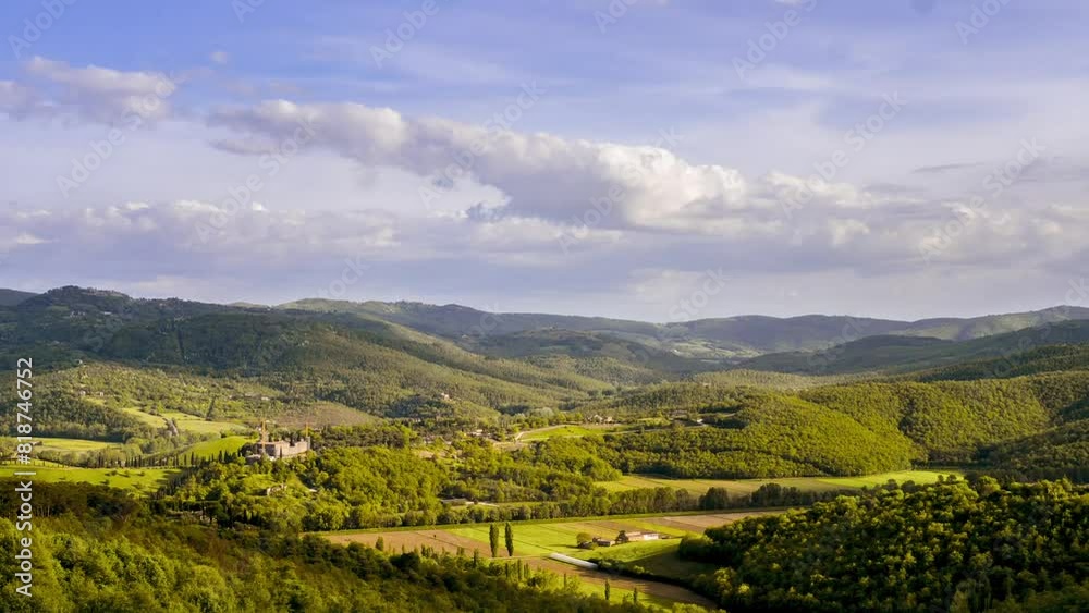 Timelapse shot of the white clouds moving in the blue sky over green mountains of Tuscany, Italy Timelapse shot of the white clouds moving in the blue sky over green mountains of Tuscany, Italy