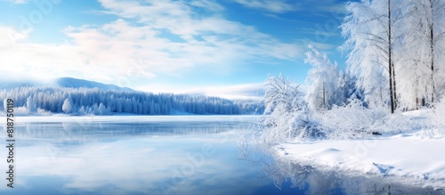 During the winter season a calm lake with snow covered shores is beautifully captured in this panoramic image providing ample copy space © HN Works