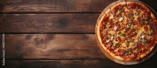 Toned image of a delicious homemade pizza on a rustic wooden table with plenty of copy space