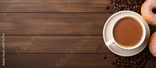 A top down view of a table with a coffee cup a donut and empty space for your text. Creative banner. Copyspace image